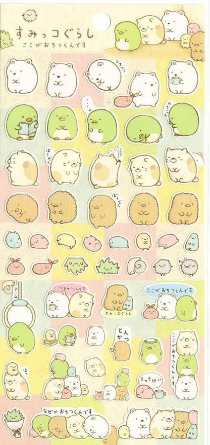 A sheet of Sumikko Gurashi stickers featuring various colorful character designs with gold foil paper accents.